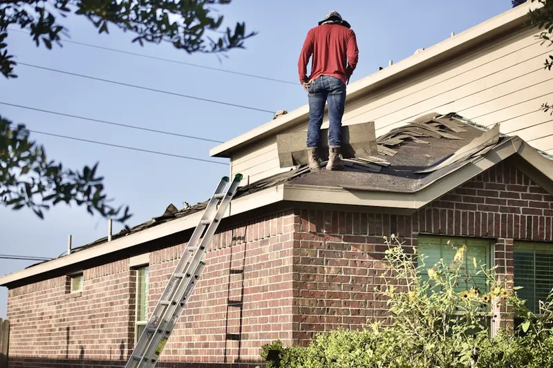 Professional roofer working on a residential roof in Lyons Plain